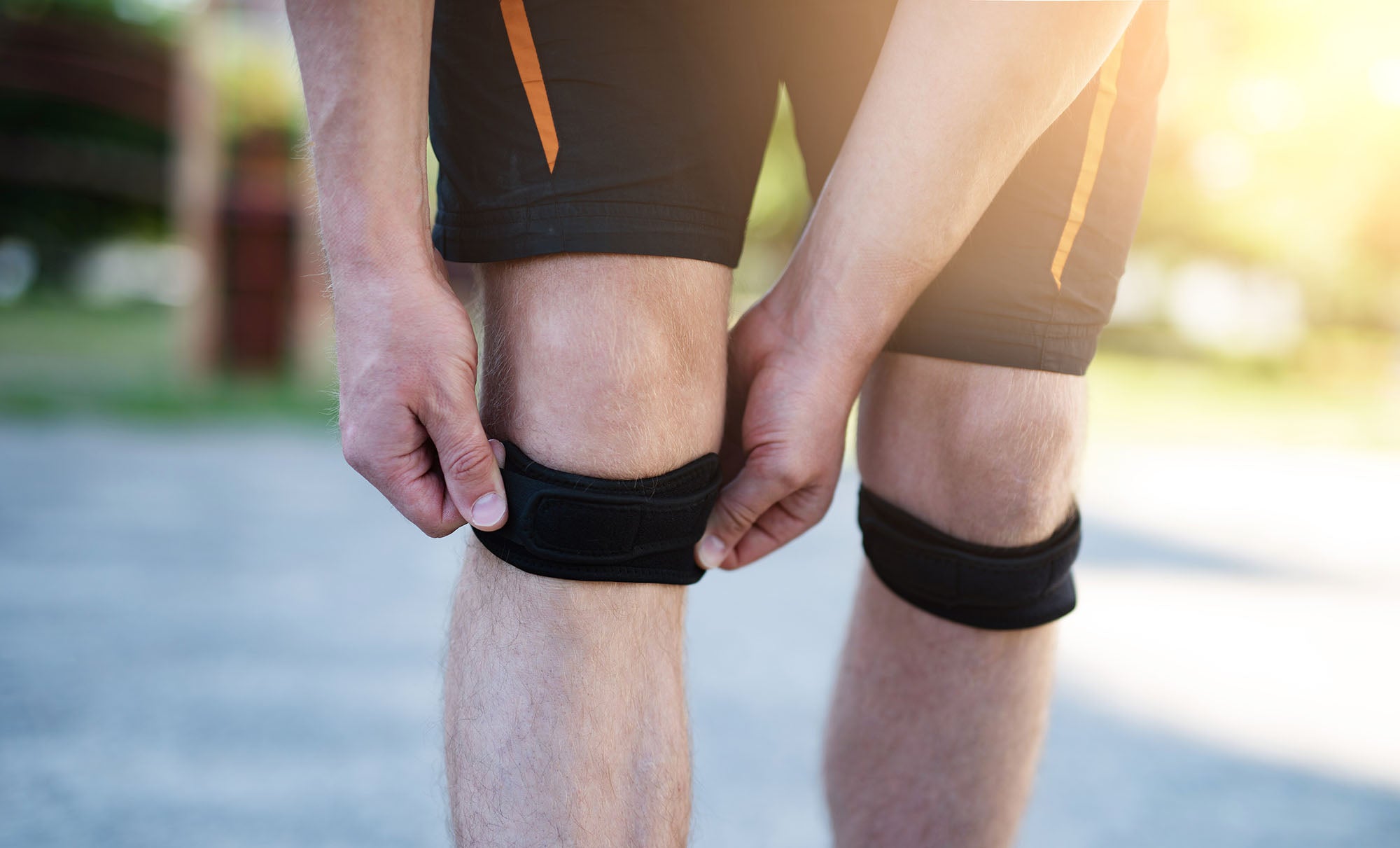Person wearing black knee straps outdoors